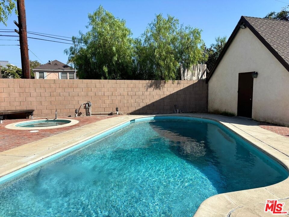 a view of a backyard with potted plants