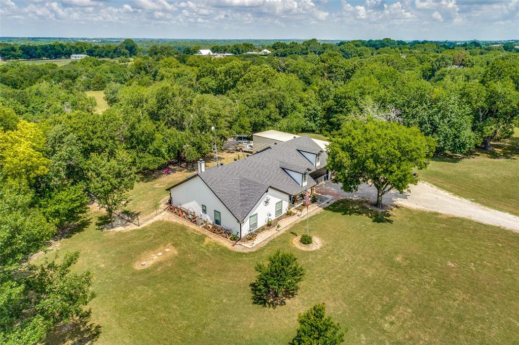 an aerial view of a house with pool yard seating area and yard