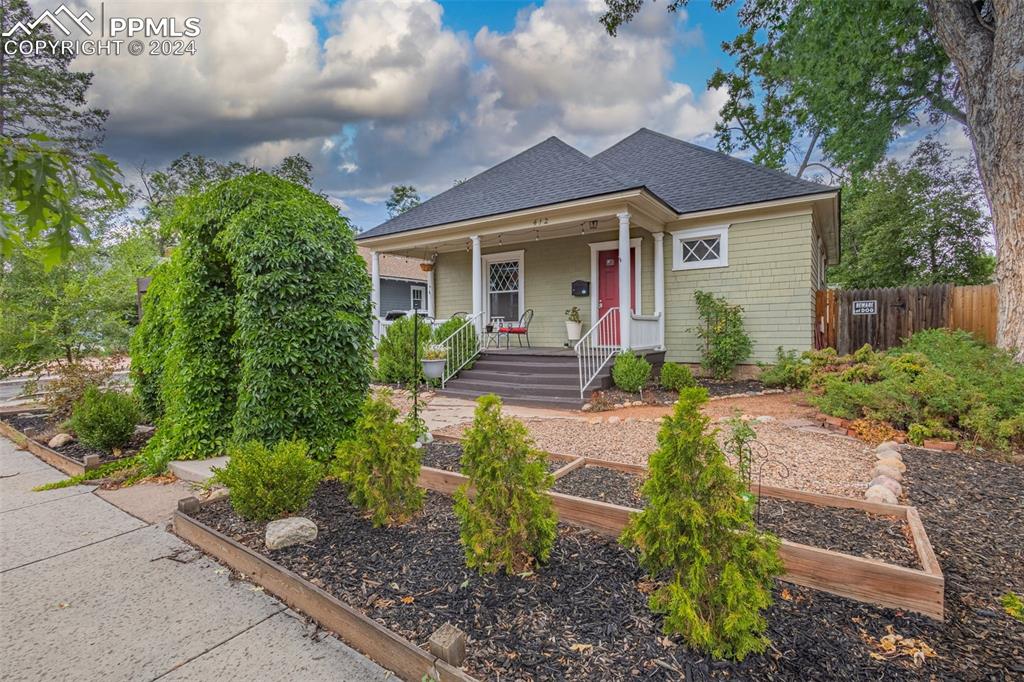 a front view of a house with garden