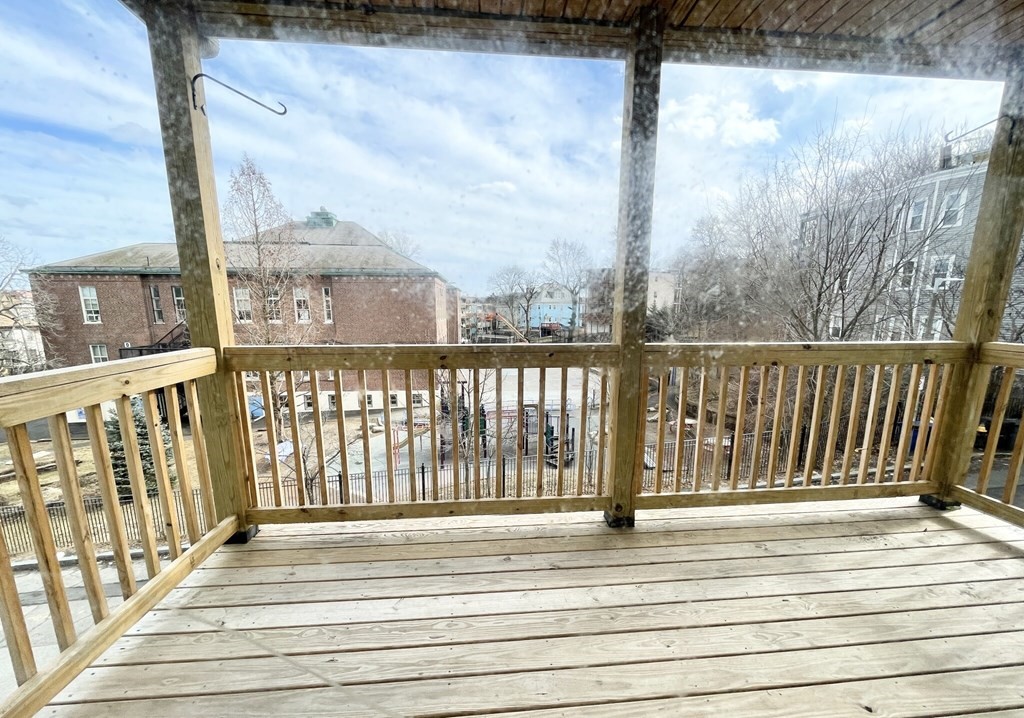 a view of a balcony with wooden floor