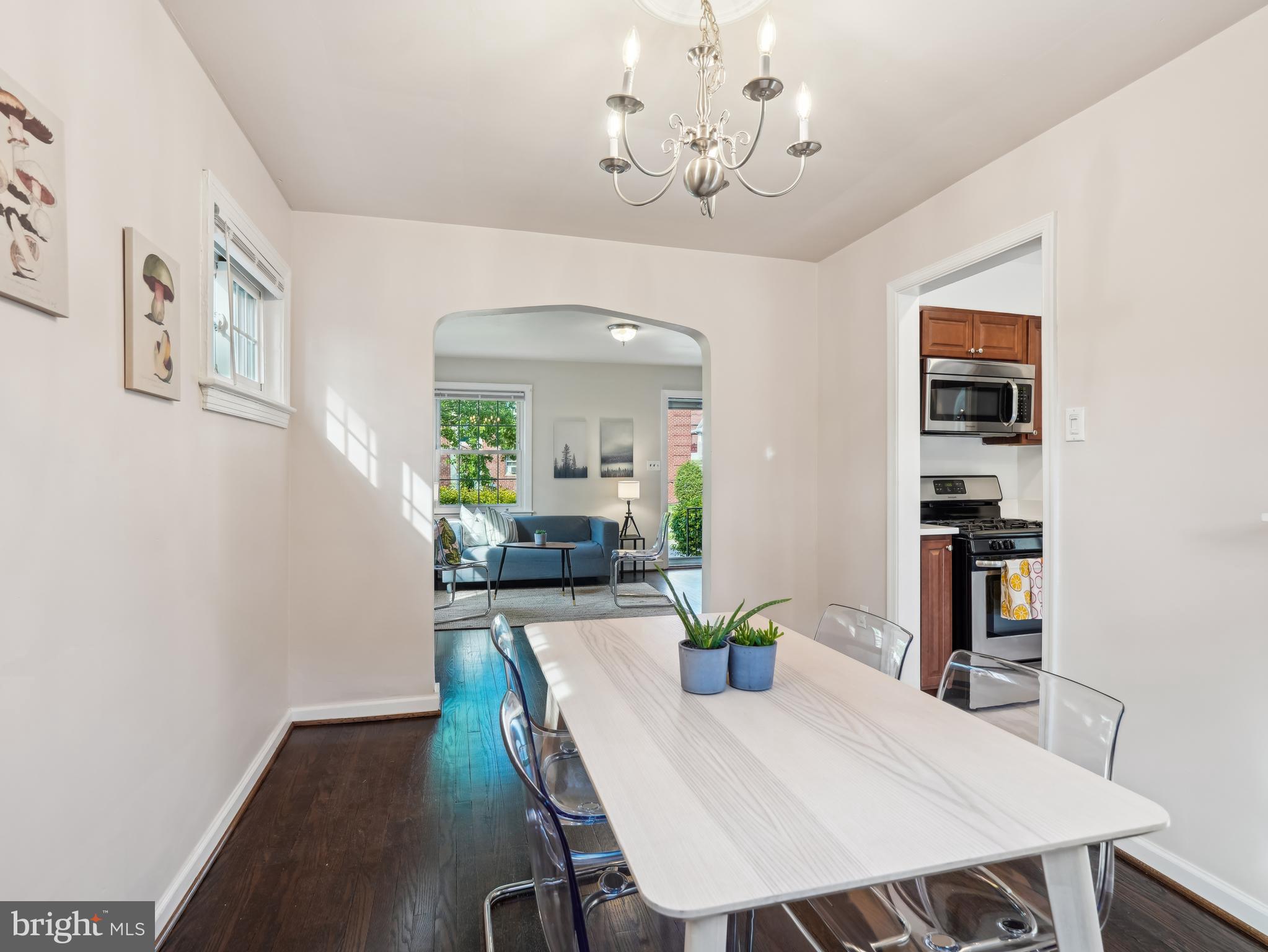 a view of a dining room with furniture and chandelier