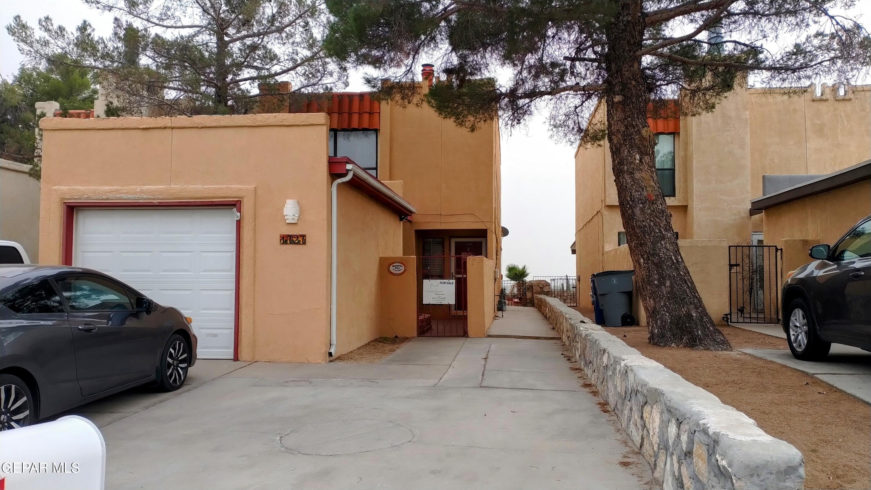 a view of a car park in front of a house