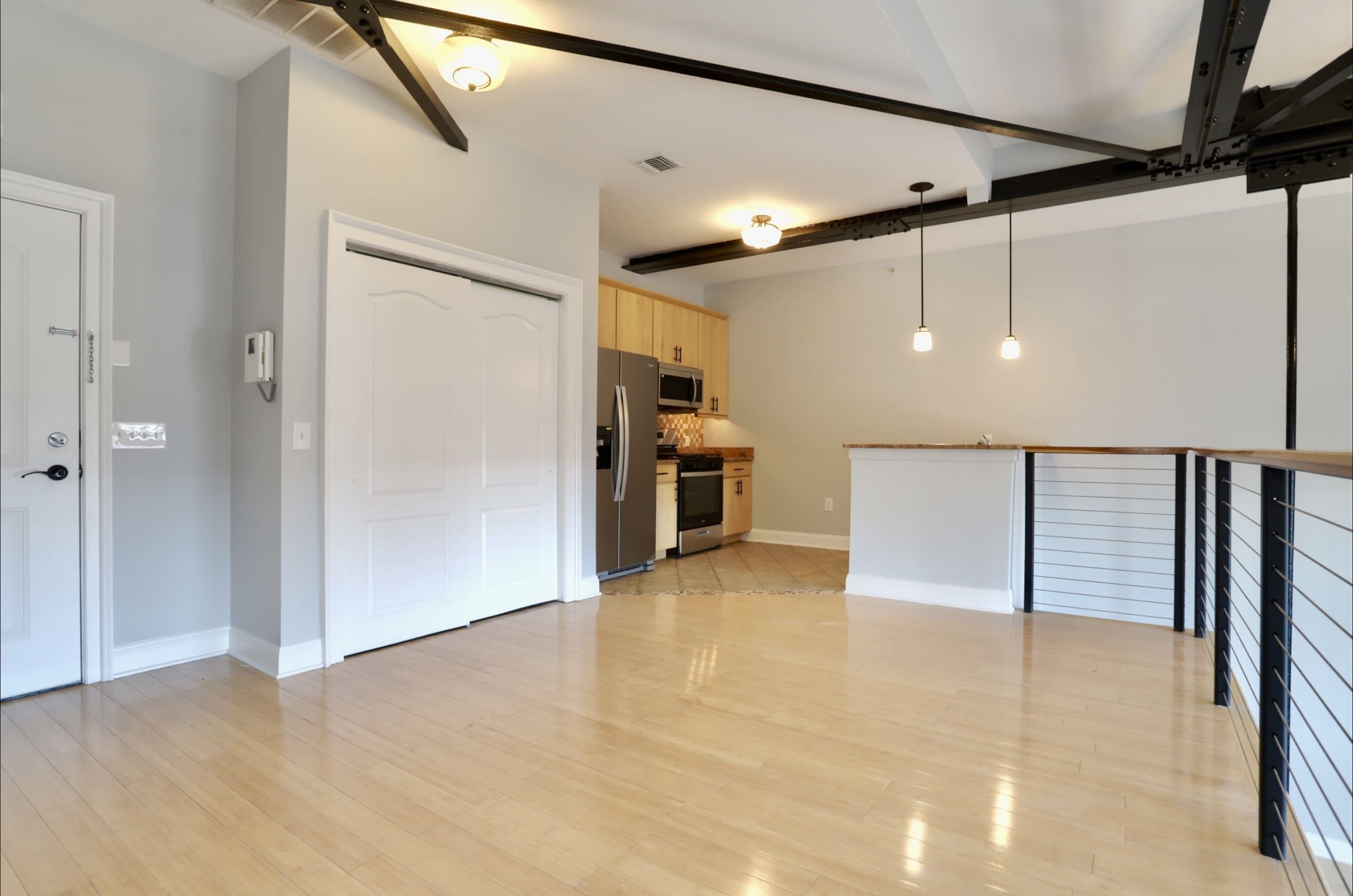 a view of a big room with wooden floor and staircase