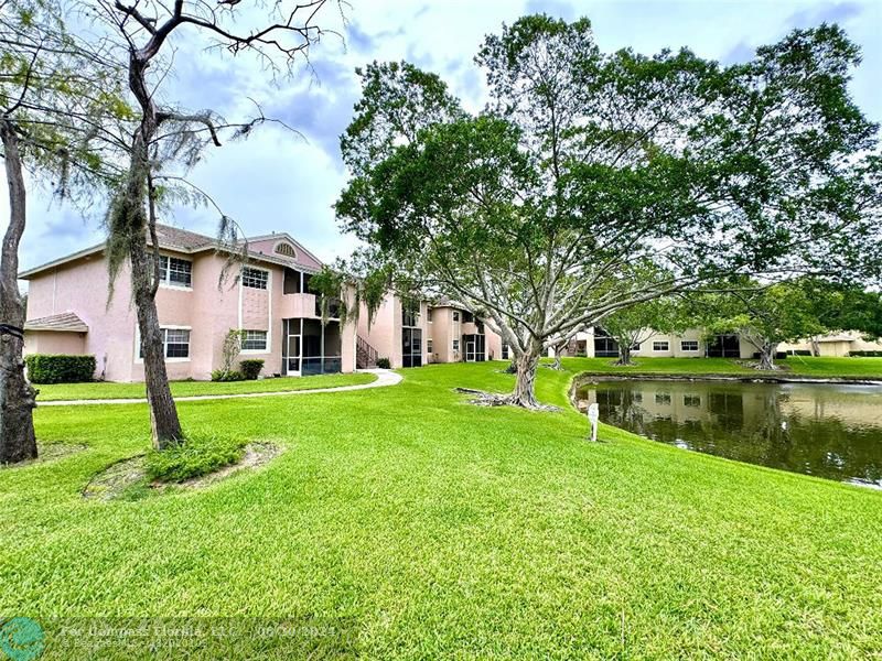 a view of a house next to a yard and lake view