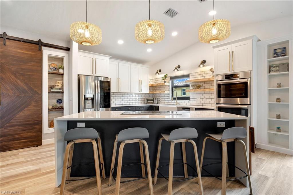 a kitchen with granite countertop a counter space cabinets and stainless steel appliances