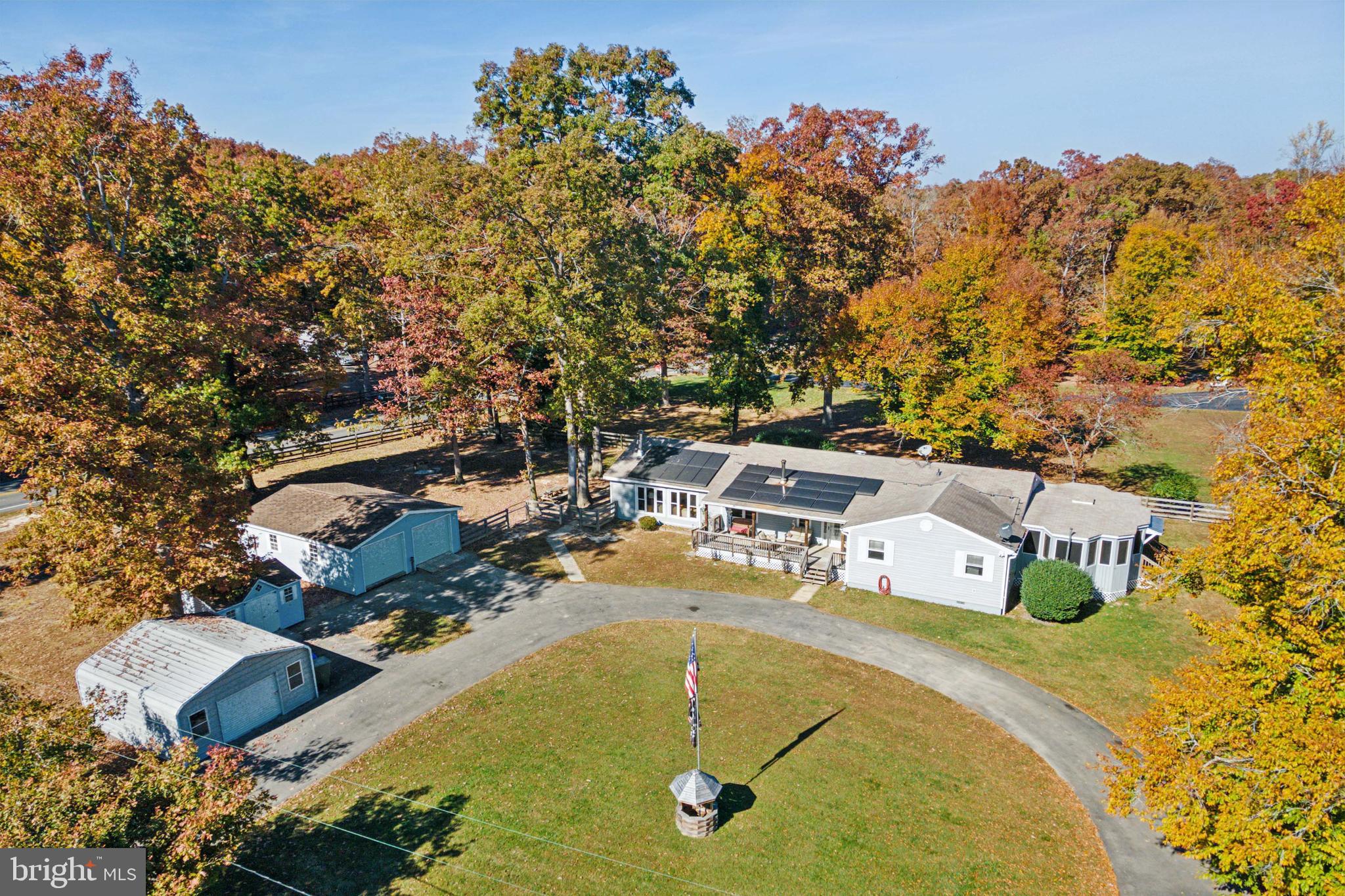 an aerial view of a swimming pool with outdoor seating