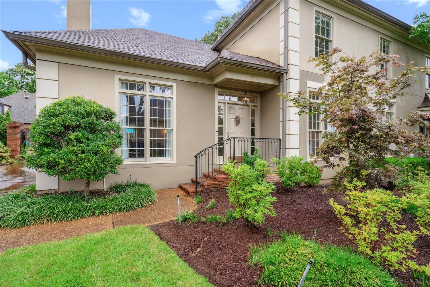 a front view of a house with garden