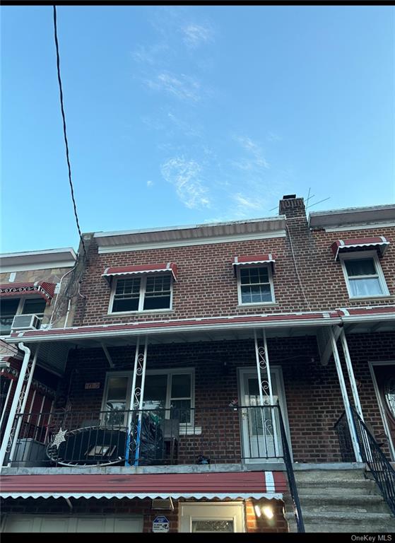 a view of house with roof deck and seating space