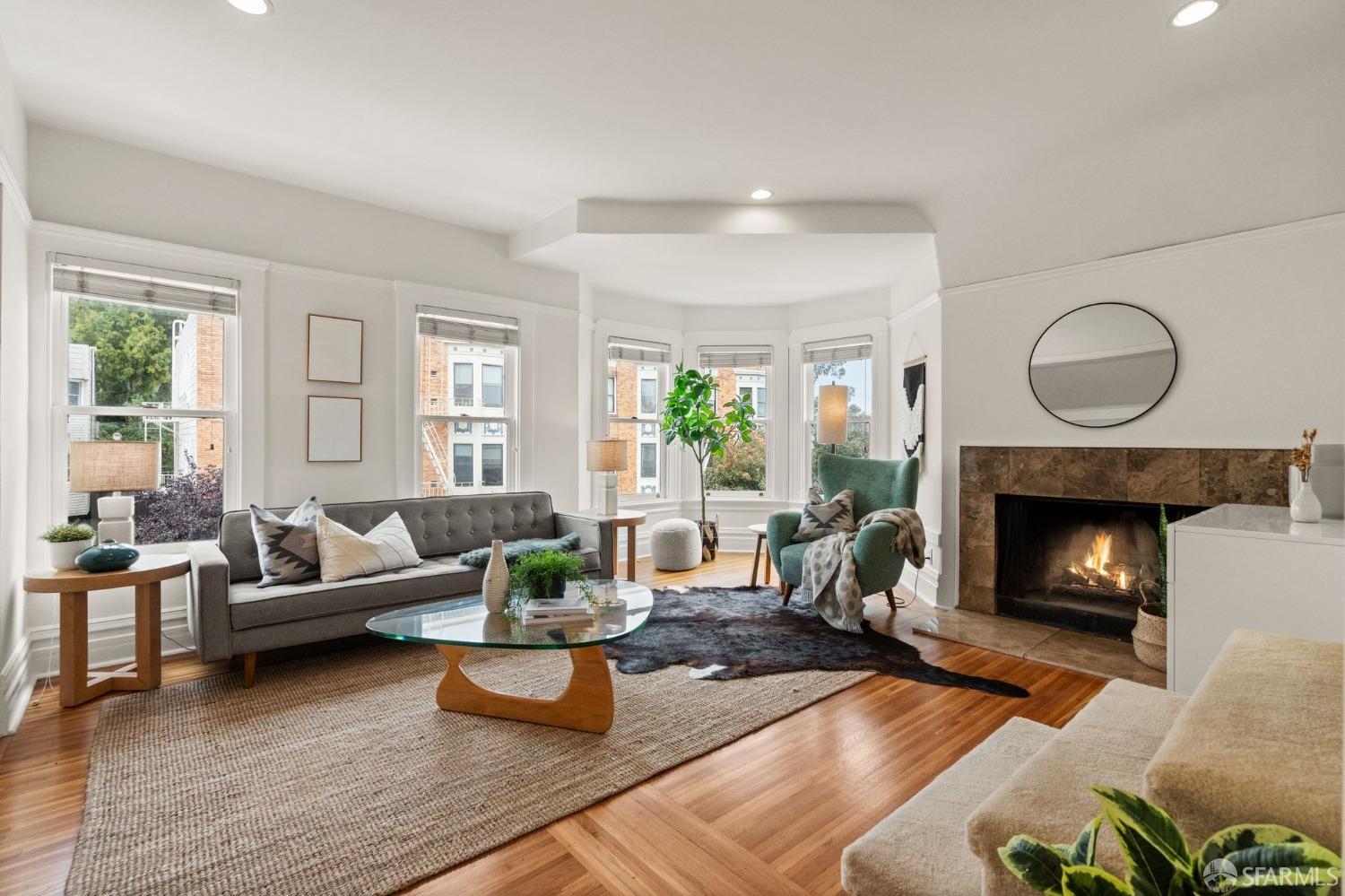 a living room with furniture and a fireplace