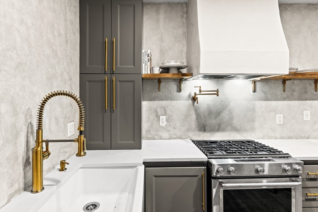 a stove top oven sitting inside of a kitchen