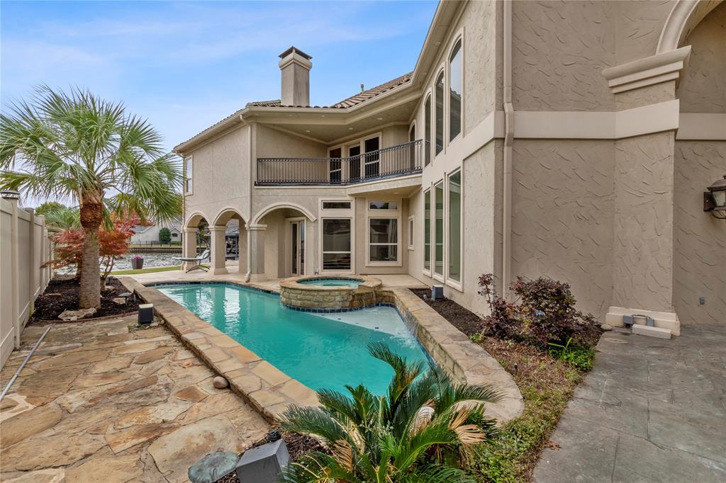 a front view of a house with swimming pool having outdoor seating