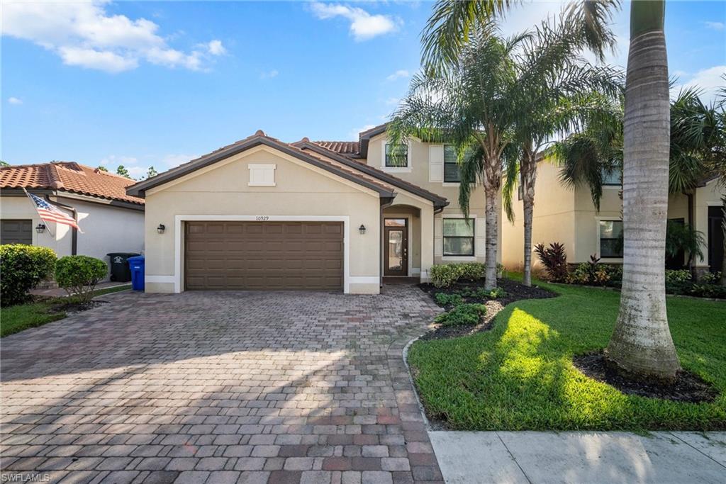 a front view of a house with a yard and garage