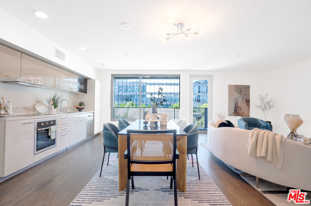 a dining room with furniture a large window and a rug