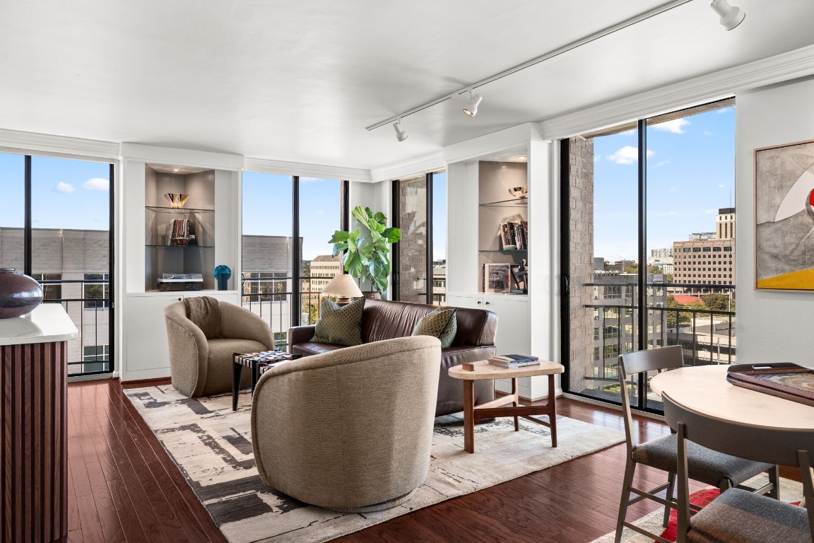 a living room with furniture and large windows