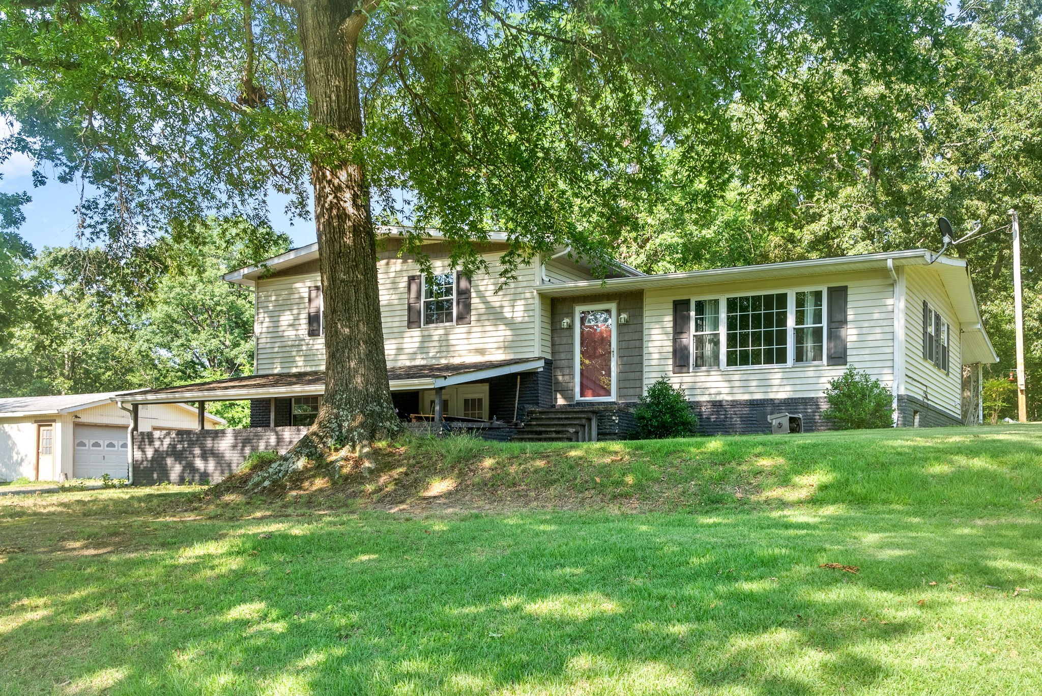 a view of backyard of house with green space