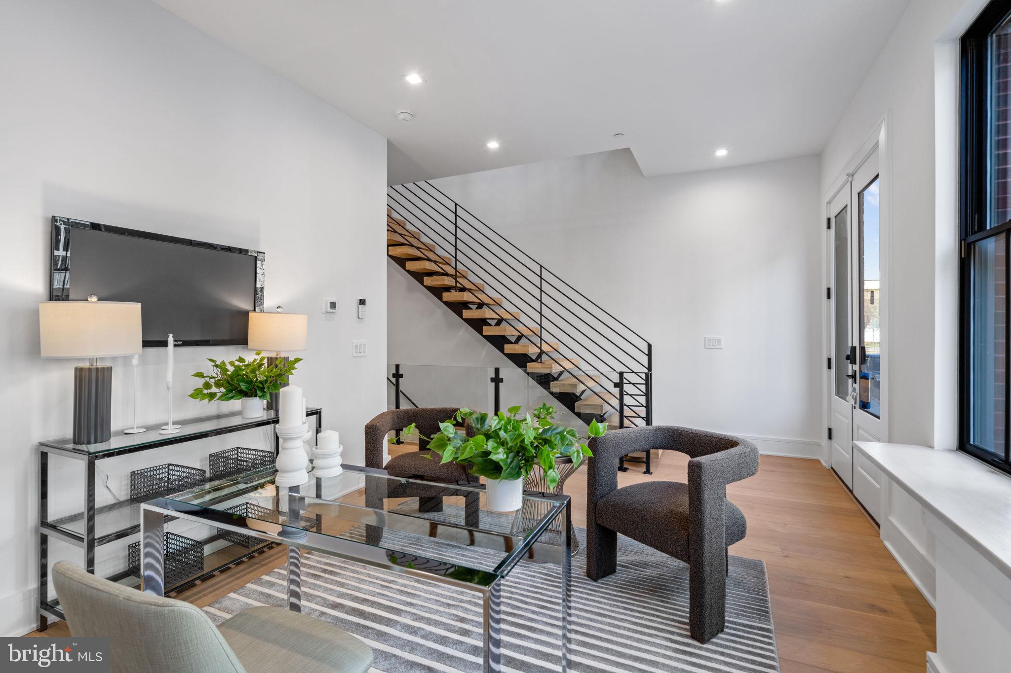 a living room with furniture and a potted plant