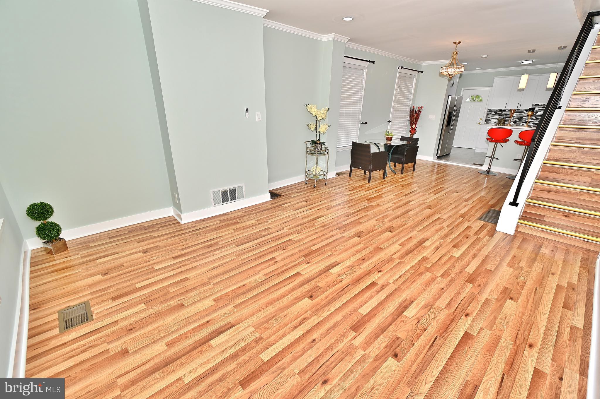 a room with wooden floor and furniture