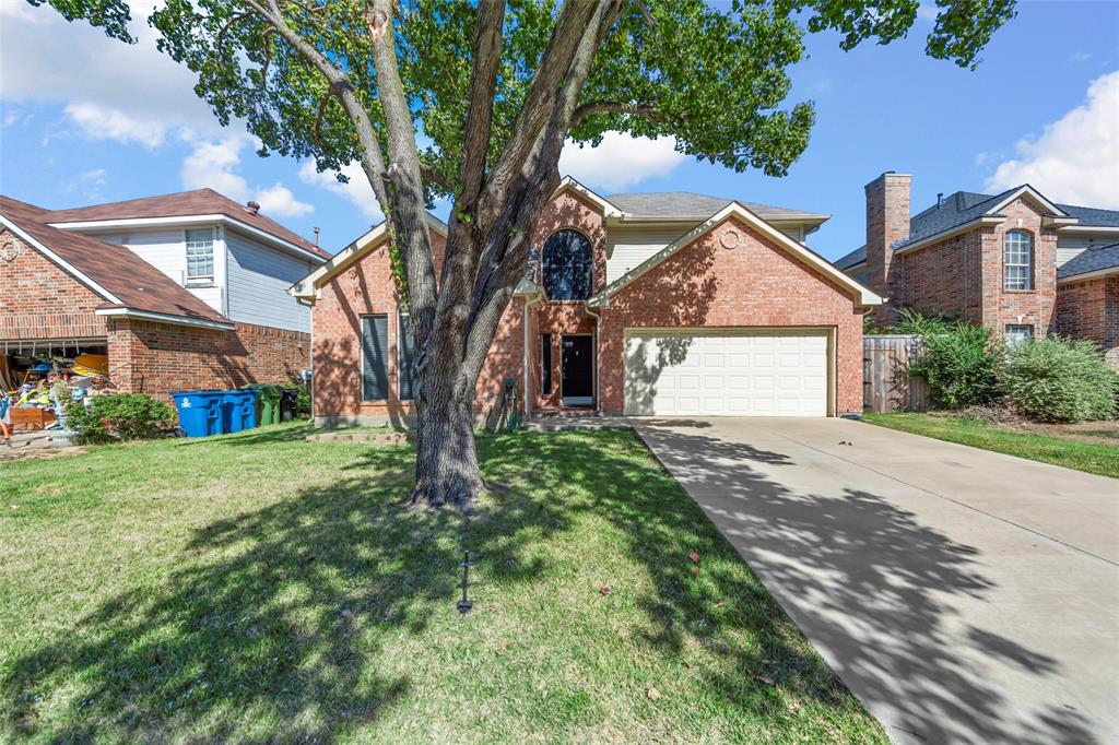 a view of a house with a tree in the yard