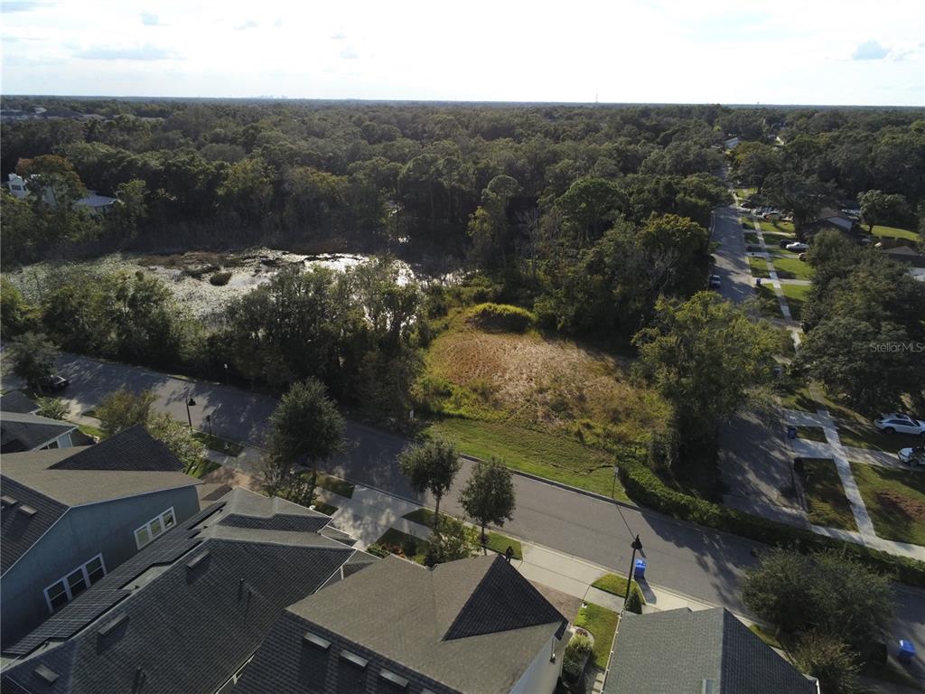 an aerial view of a house with yard