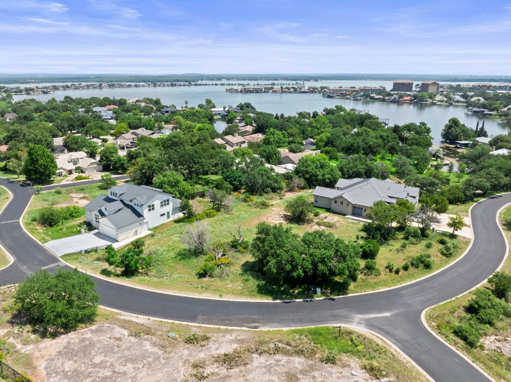 an aerial view of a house with a garden and lake view