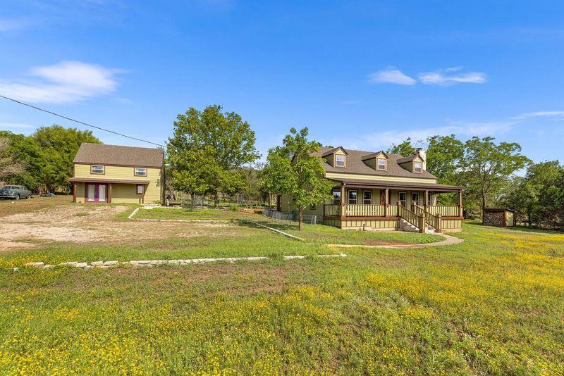 a front view of a house with a big yard