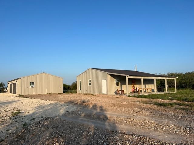 a view of a house with a backyard