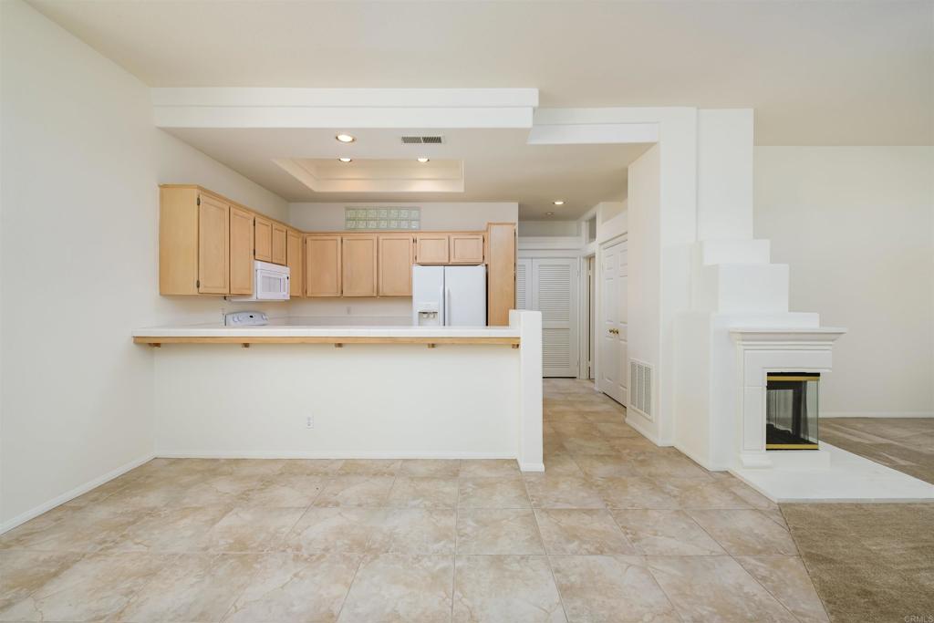 a view of a kitchen with a sink and cabinets