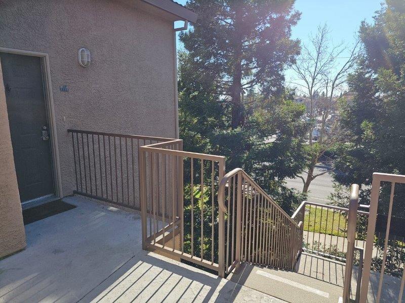 a view of balcony with wooden floor and fence