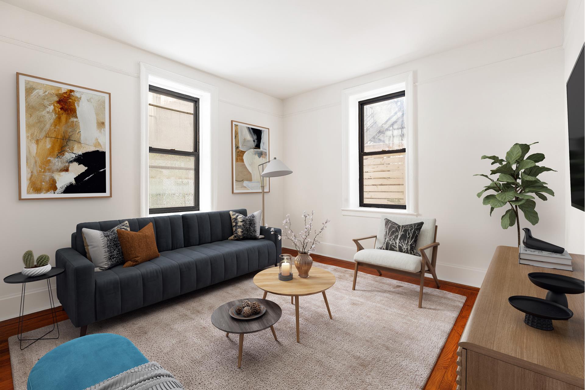 a living room with furniture and a potted plant next to a window