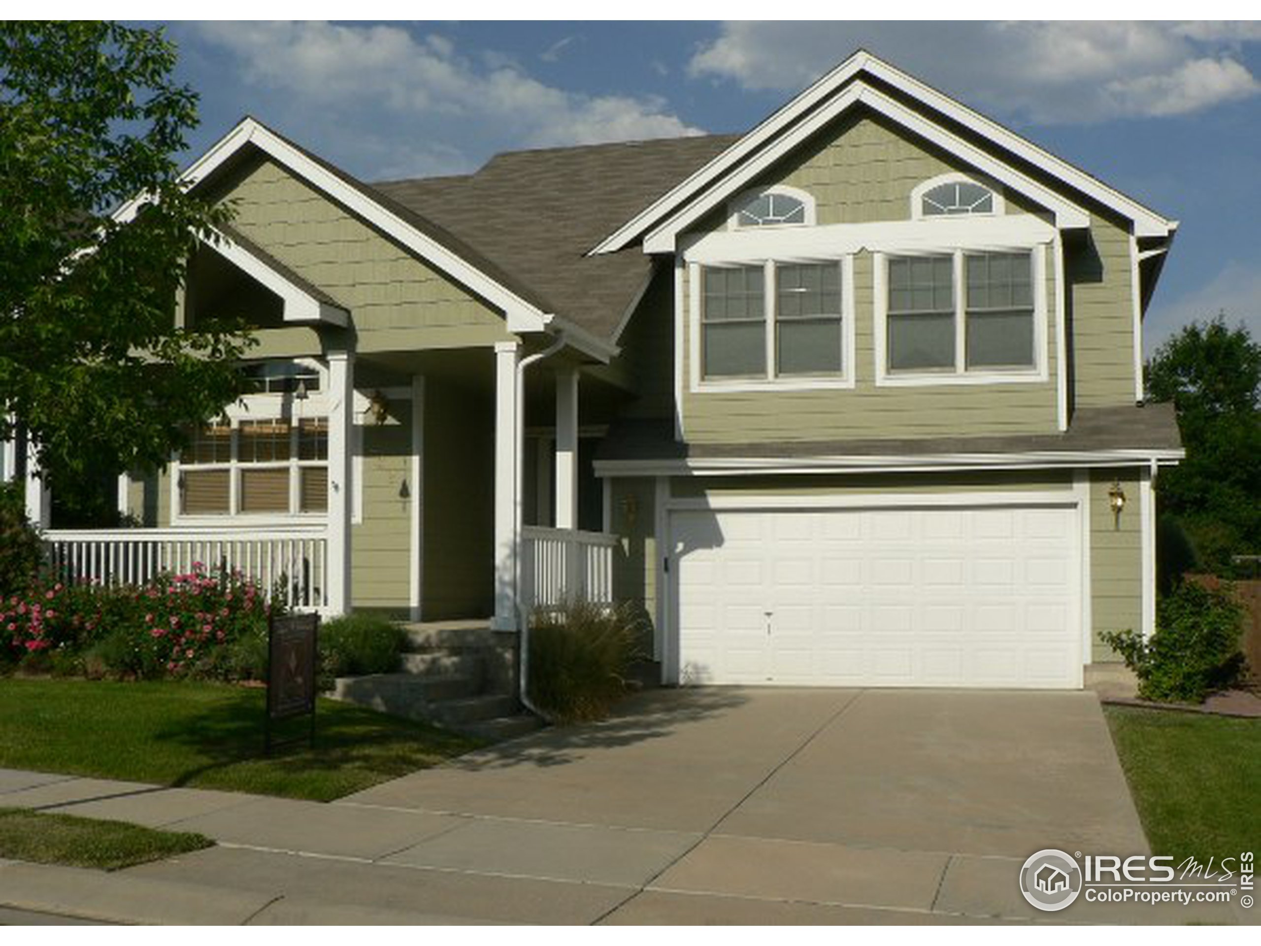 a front view of a house with a yard and outdoor seating