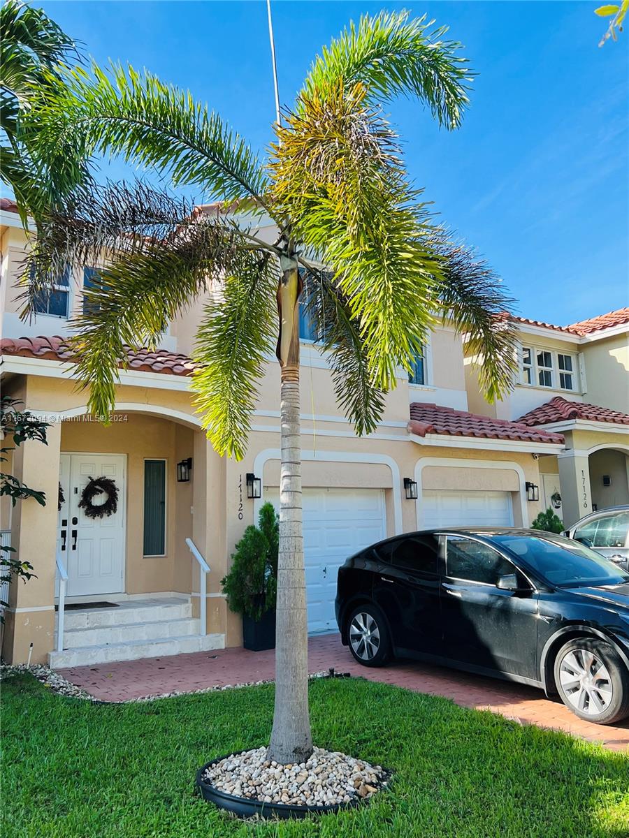 a front view of a house with garden