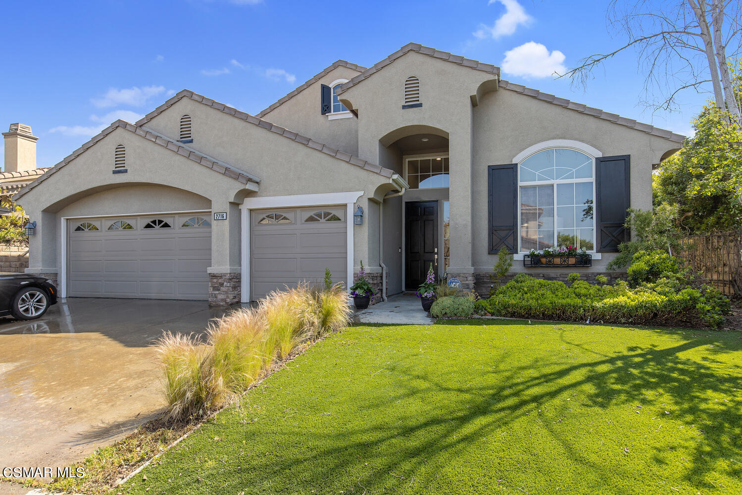 a front view of a house with garden