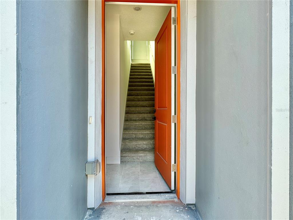 a view of a hallway with stairs