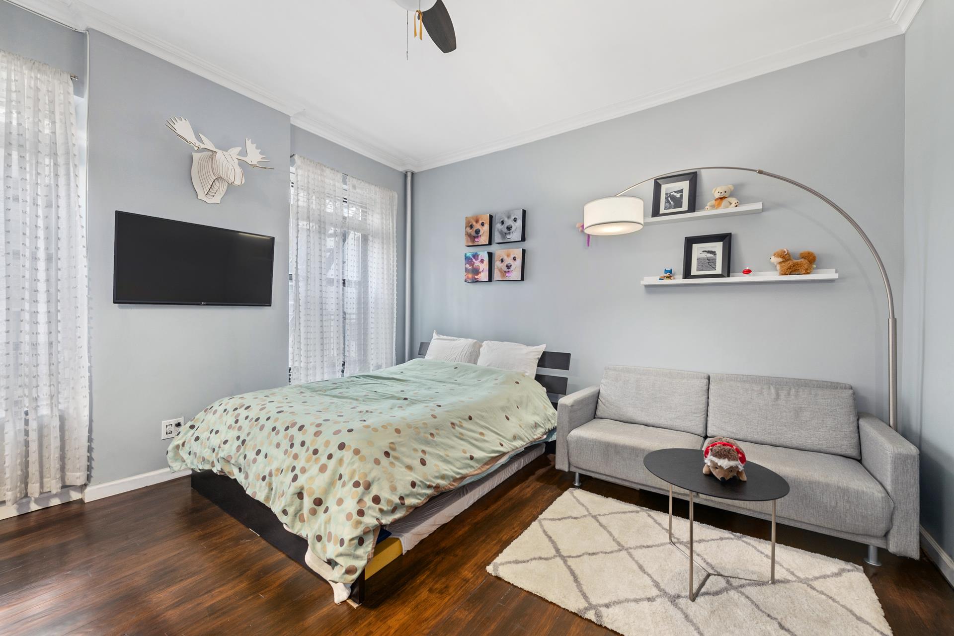 a bedroom with a bed and a flat screen tv