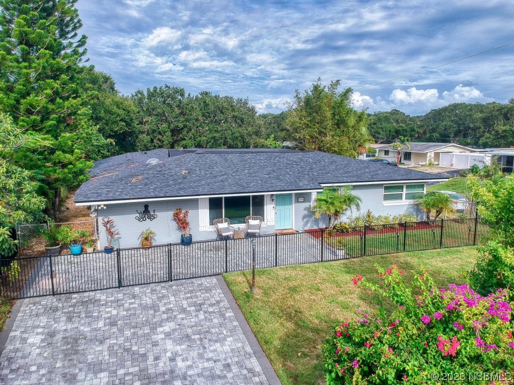 a view of a house with a yard and garden