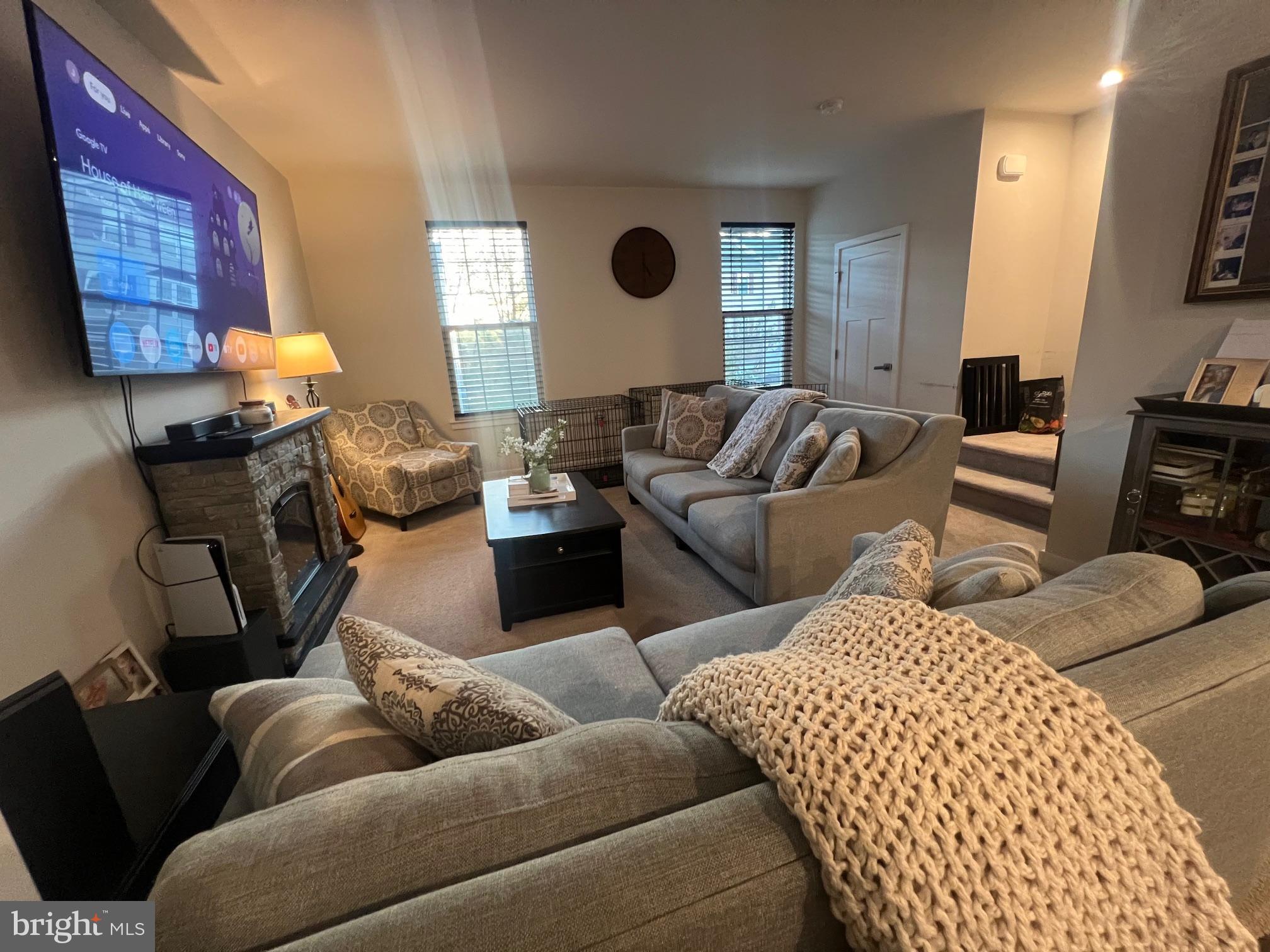 a living room with furniture and a lamp