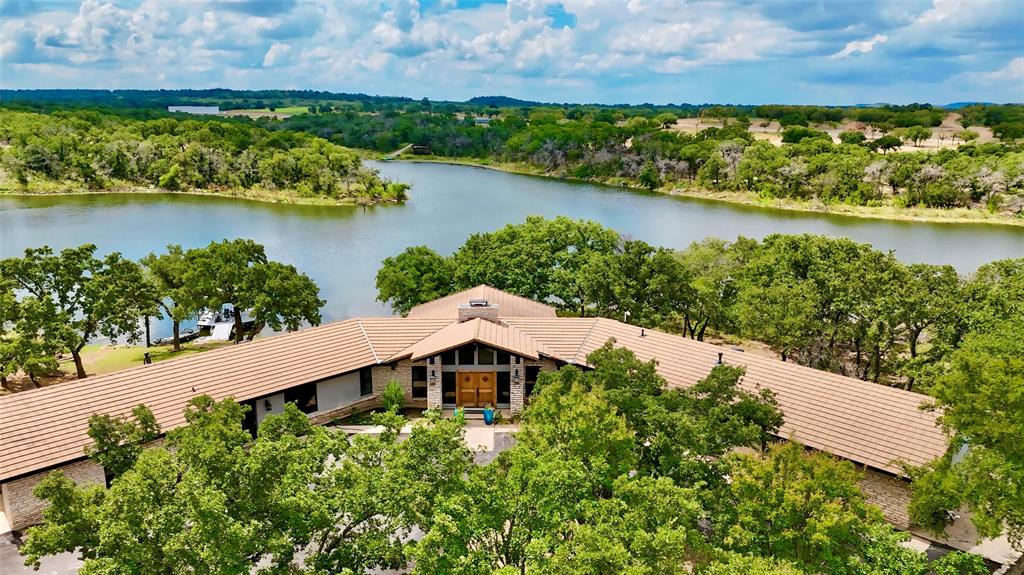 an aerial view of a house with a lake view