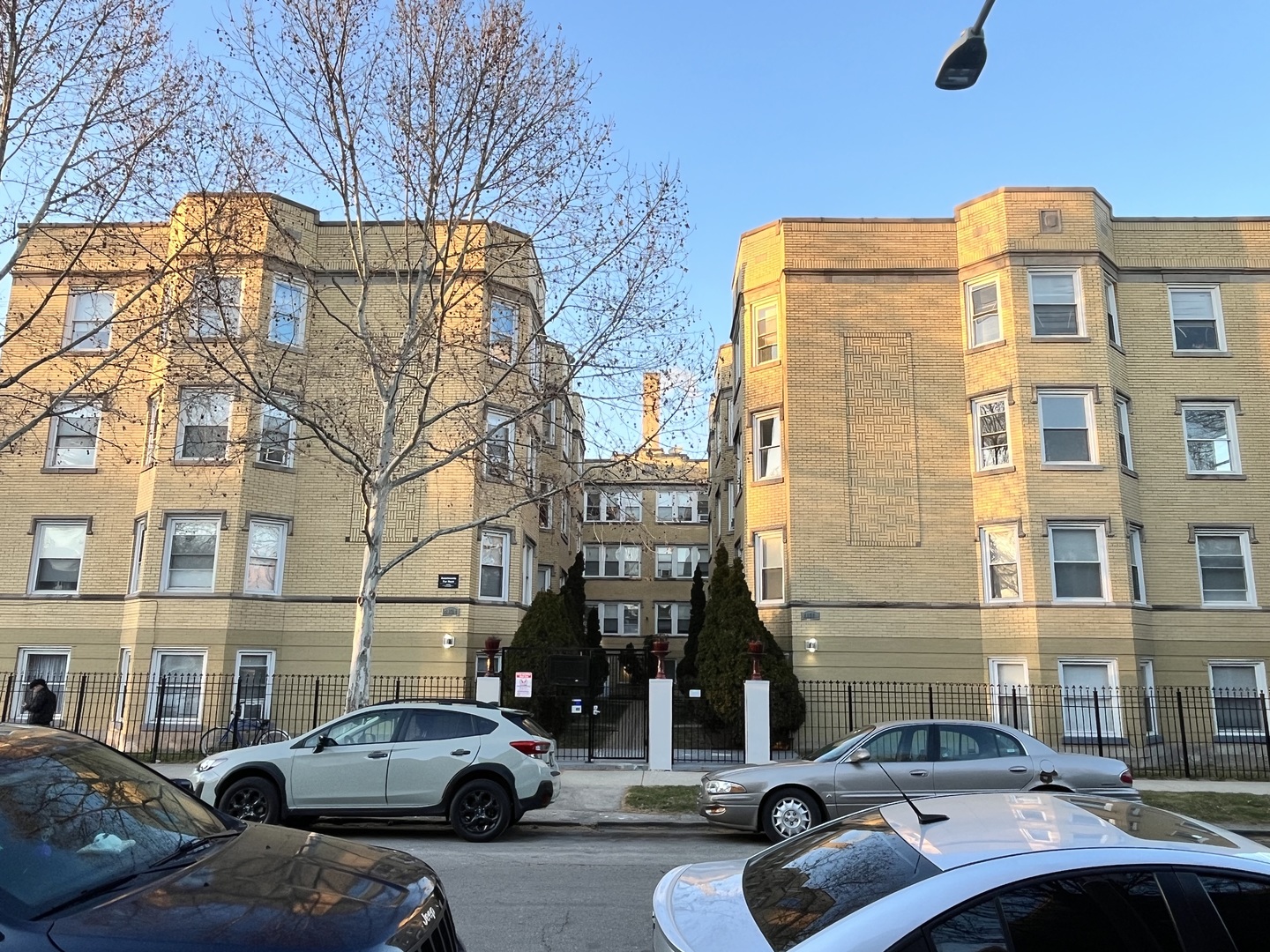 a couple of cars parked in front of a building