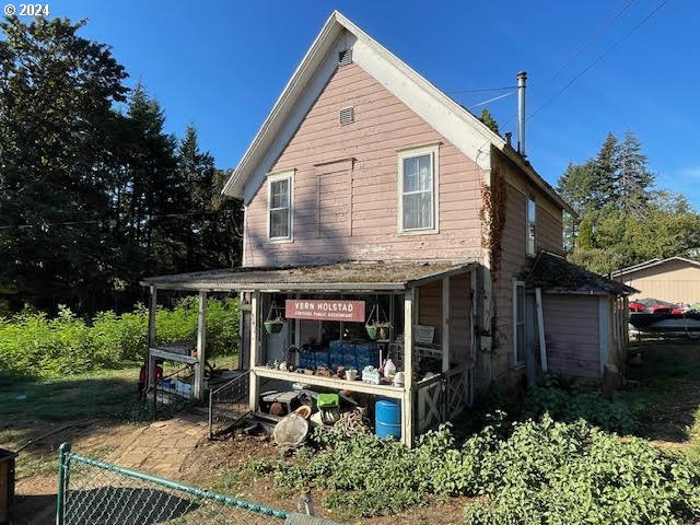 a view of a house with a yard and sitting area