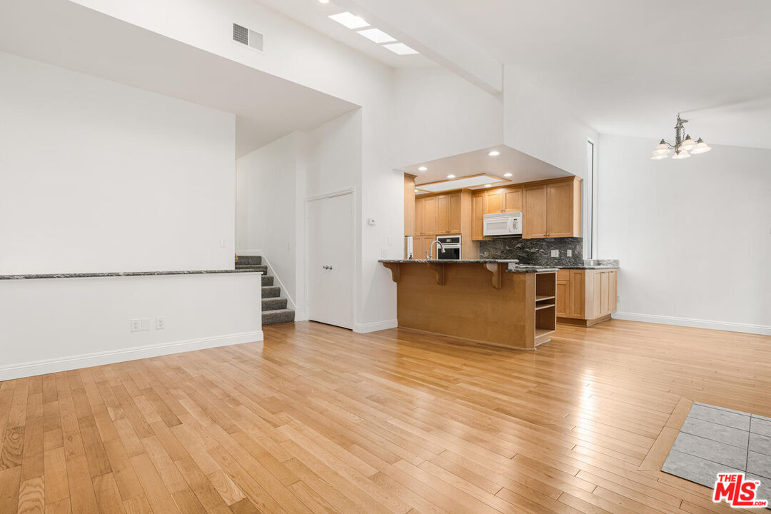 a view of a kitchen with a sink and a microwave