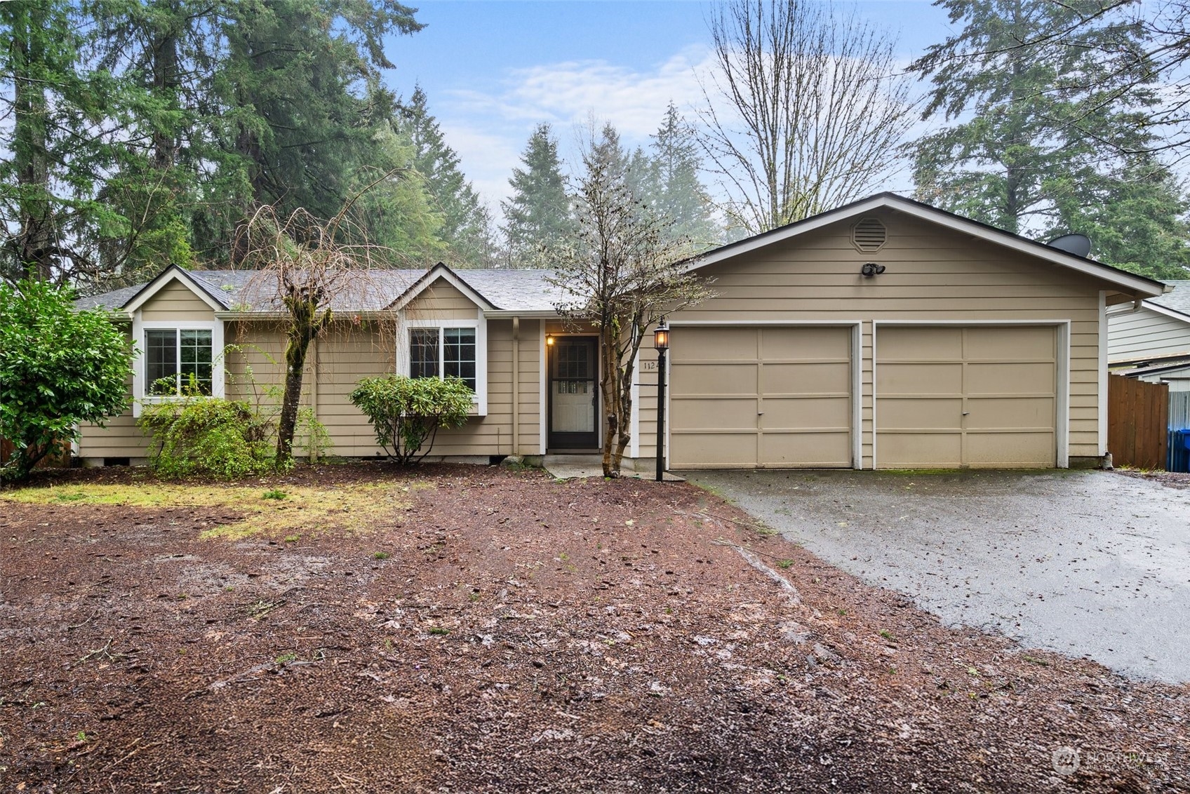 a view of a house with a yard and large tree