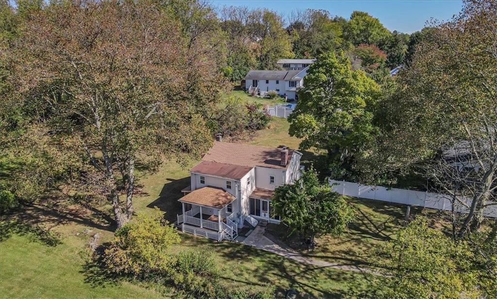 an aerial view of a house with a yard