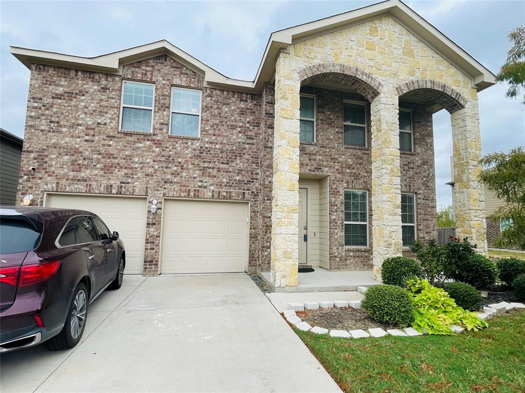 a front view of a house with parking space