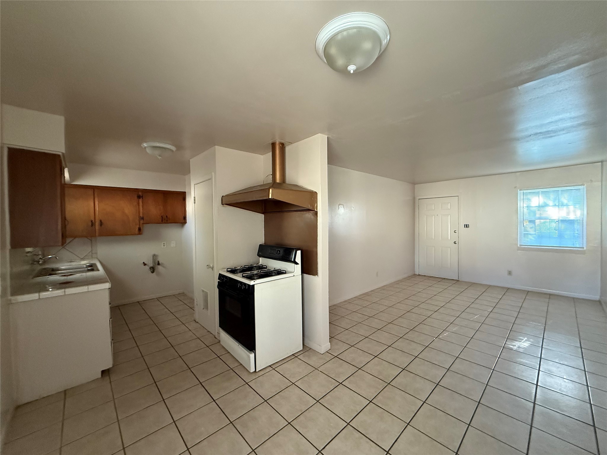 a kitchen with cabinets and steel appliances