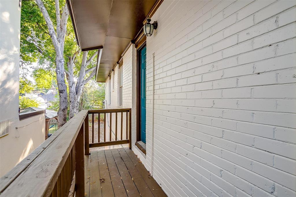 a view of balcony with wooden floor and fence