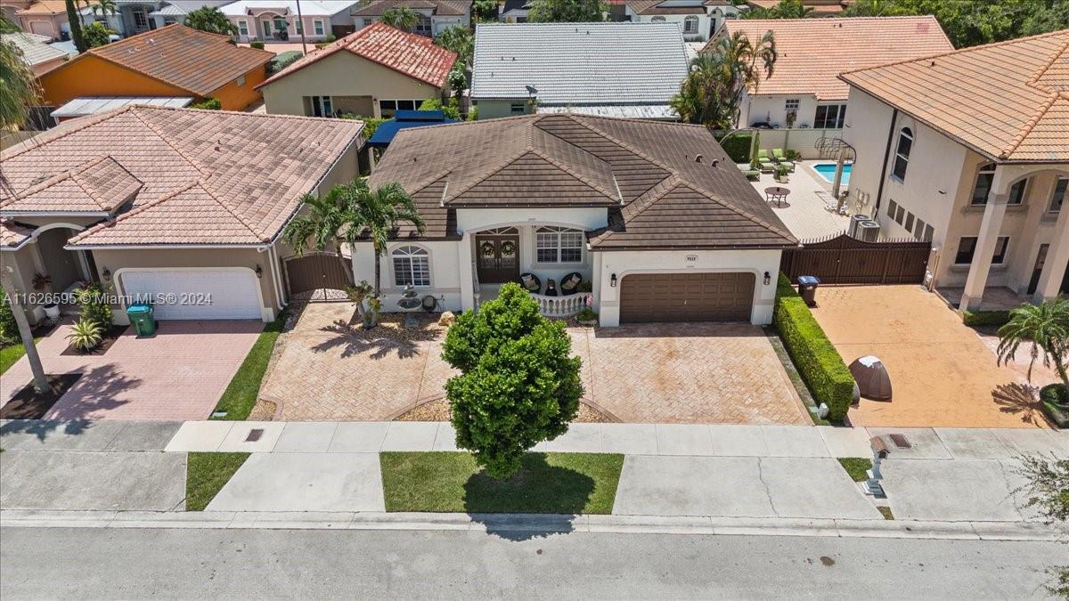 an aerial view of a house with yard