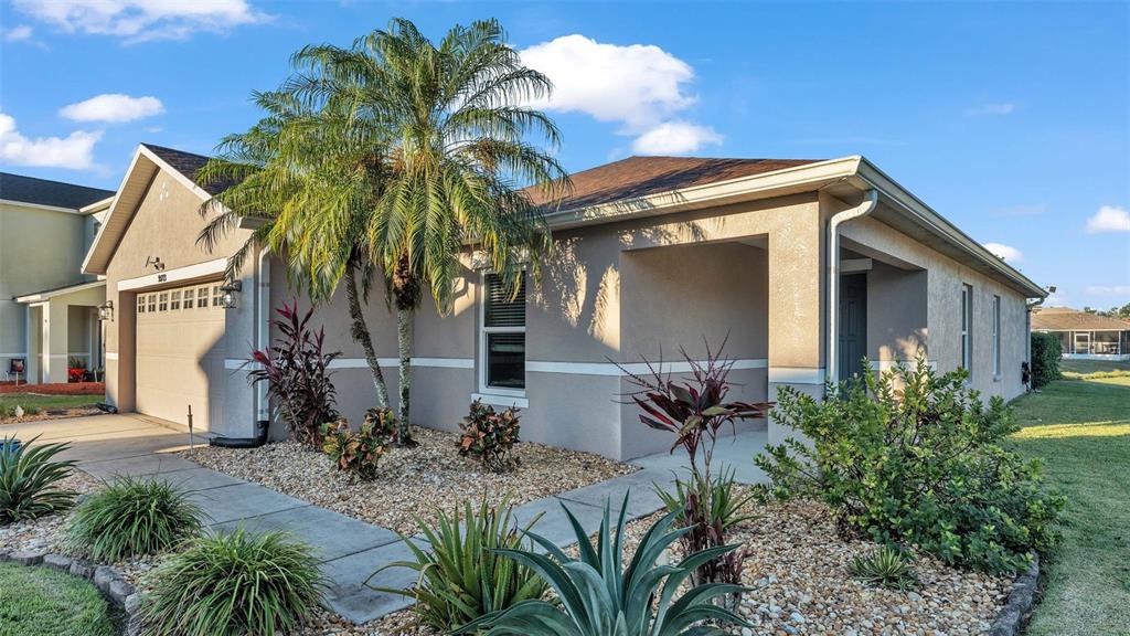 Front of home with beautifully manicured yard.