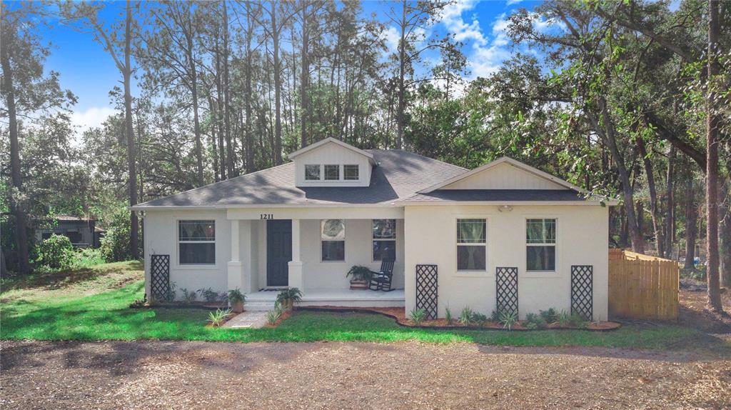 a front view of house with yard and green space