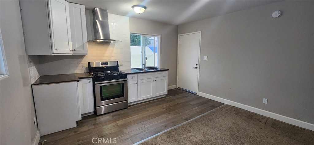 a kitchen with granite countertop white cabinets and white appliances