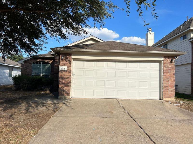 a front view of a house with a garage